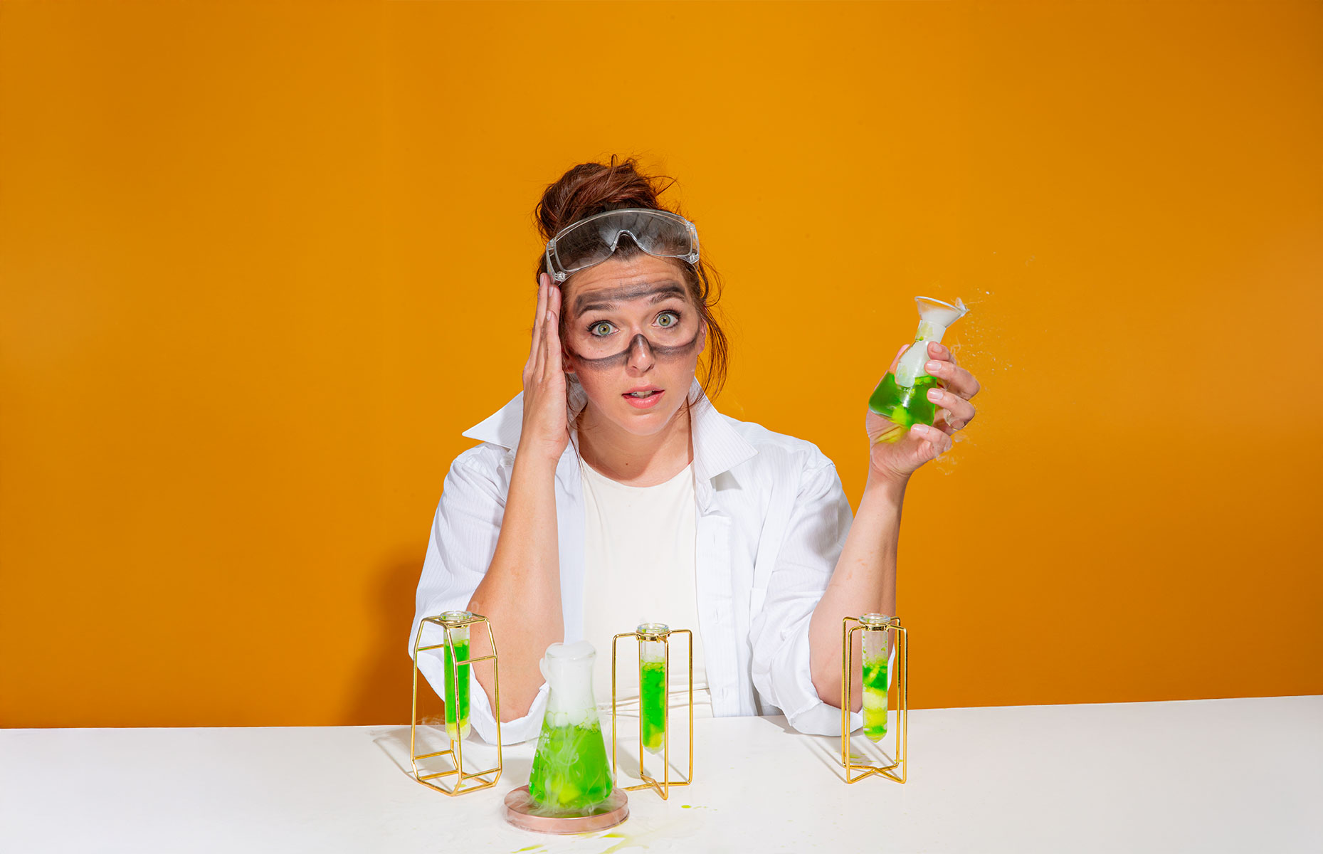 amanda wolfe found of growco lab appearing as a chemist with flask of bubbling green liquid